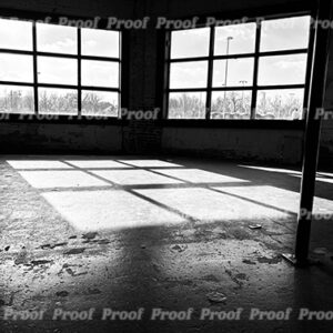 Black and white photograph of an empty studio with large windows and sunlight on the floor, used as Anatomy of Release chapter art