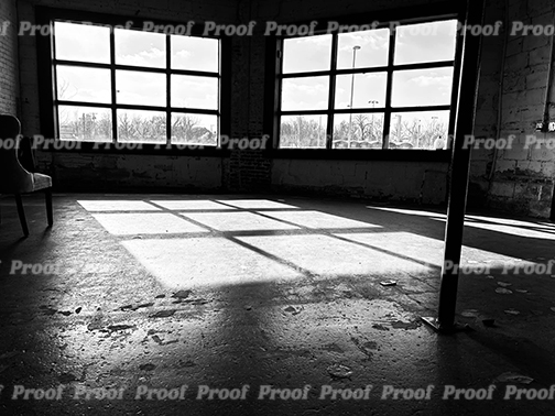 Black and white photograph of an empty studio with large windows and sunlight on the floor, used as Anatomy of Release chapter art