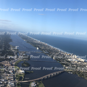 Aerial view of coastline, river, bridges, and city from an airplane window, used as Anatomy of Release chapter art