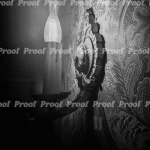 Black and white close-up of a glowing electric candle on a patterned wall, used as Anatomy of Release chapter art