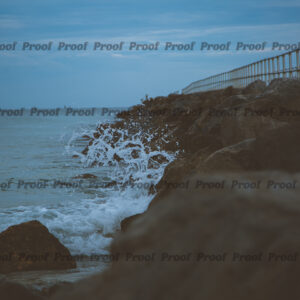 Ocean waves crashing against rocks beside a pier, used as Anatomy of Release chapter art